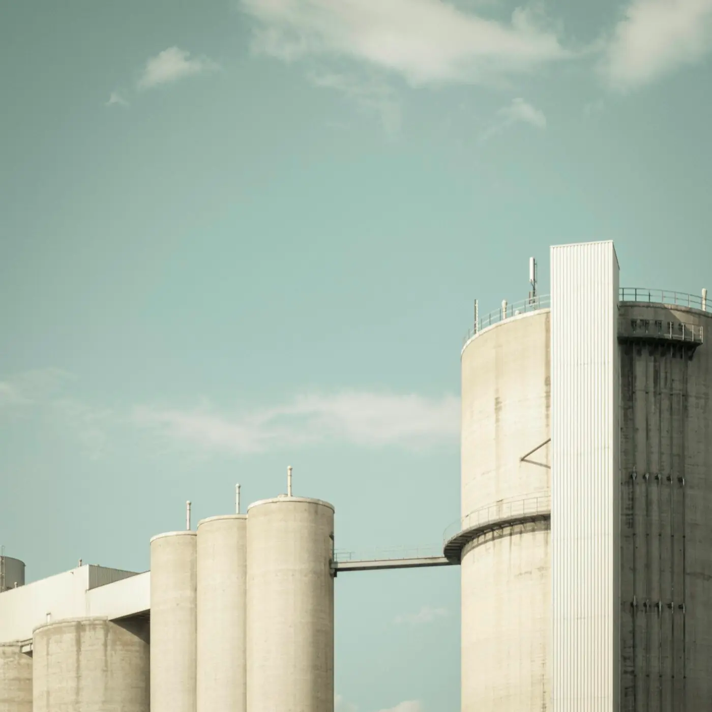 Concrete silos and storage towers against a clear sky