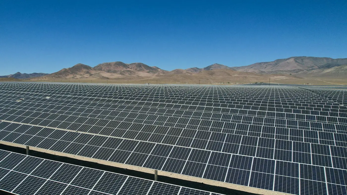 Utility-scale solar farm stretching to the mountains